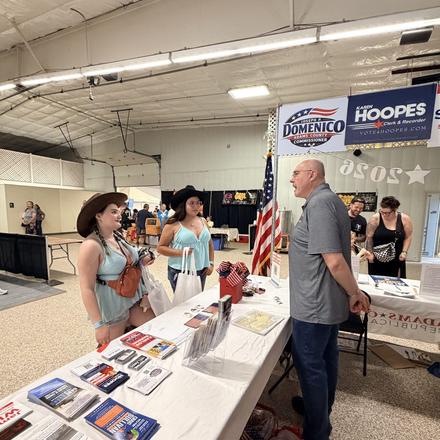 Craig Sullivan talking with fairgoers across the booth table