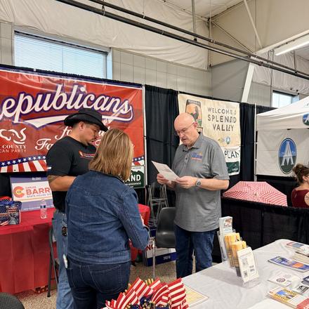 Craig Sullivan going over literature at the booth