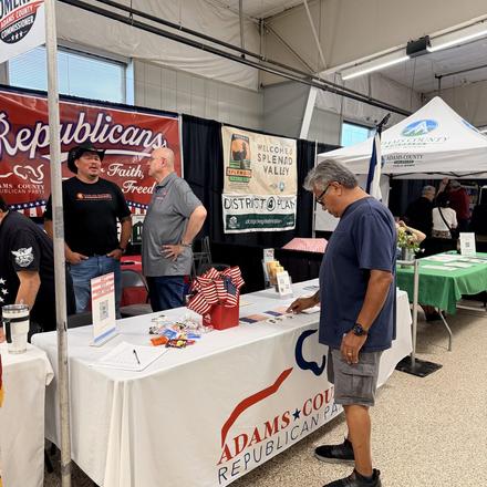 Fairgoers stopping at the county party booth