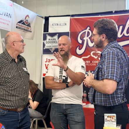 Craig Sullivan talking with visitors at the booth
