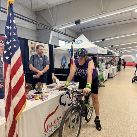 A cyclist stopping at the county party booth