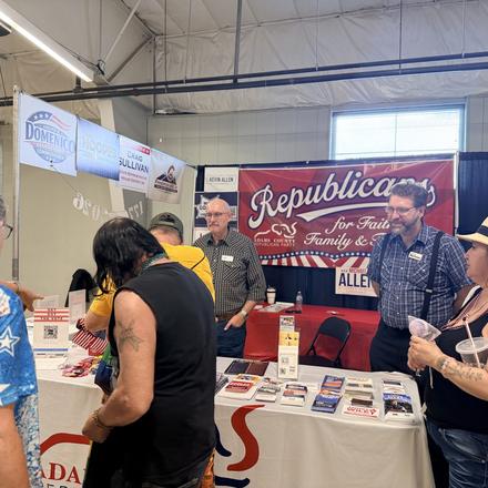 Fairgoers at the booth table