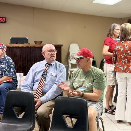 Craig Sullivan seated and talking with a member