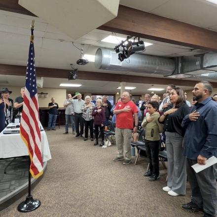 Members standing for the Pledge of Allegiance