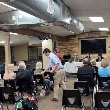 Members finding their seats before the meeting