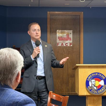 A speaker addressing the Lincoln Club from beside the lectern