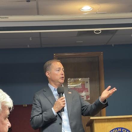 A speaker making a point to the room
