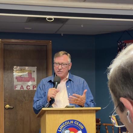 A speaker addressing members from the lectern