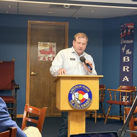 A speaker opening the program at the lectern