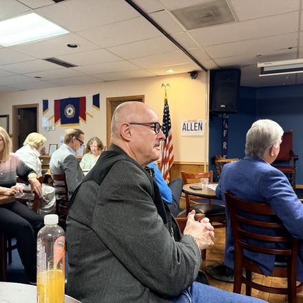 Members seated at their tables during the program