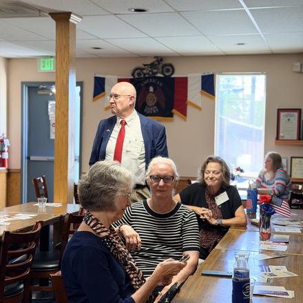 Craig Sullivan talking with guests seated along the table
