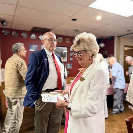 Craig Sullivan talking with a guest holding campaign literature