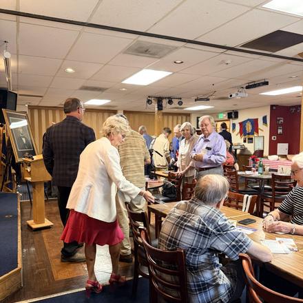 Guests moving between tables during the Lincoln Club lunch