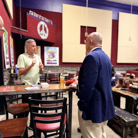 Craig Sullivan listening to a guest at the meet and greet
