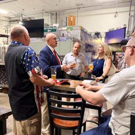 Craig Sullivan talking with guests over drinks