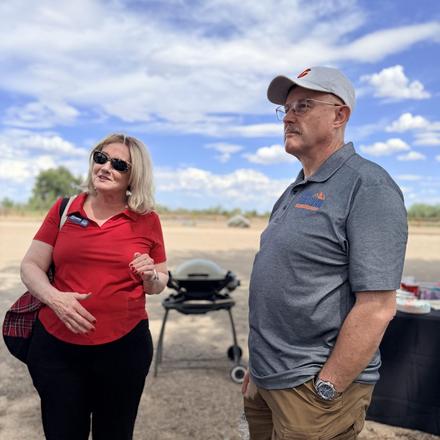 Craig Sullivan and a guest beside the grill