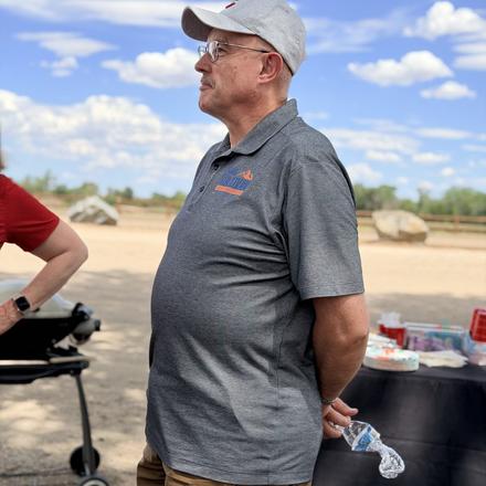 Craig Sullivan standing by the grill at the cookout