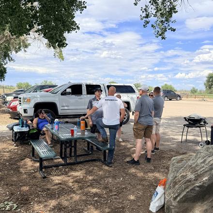 Attendees gathered around the picnic tables